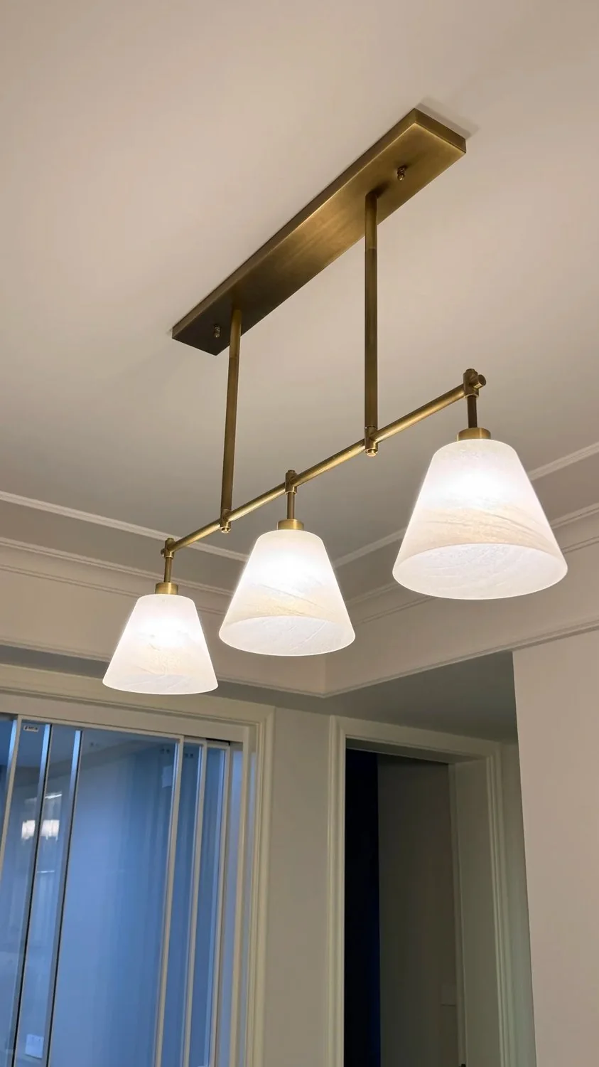 Finished brass lighting should be reviewed for color match, symmetry and clean joint details.