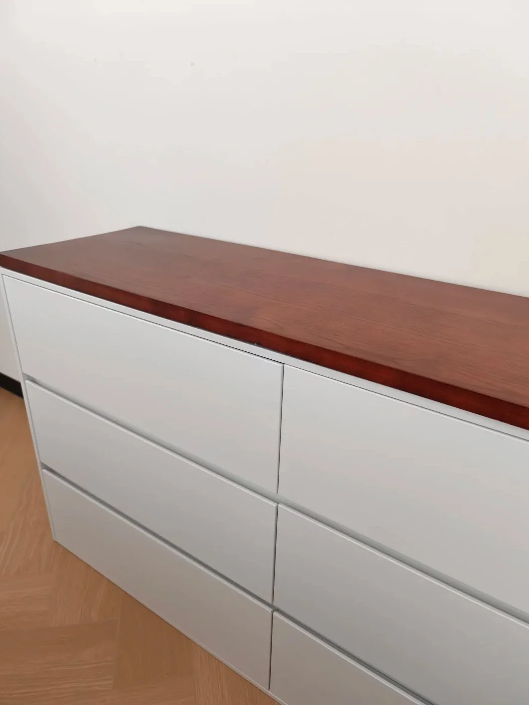 Mixed-material casegoods often rely on metal internally or in hardware even when the visible surface is wood or paint.