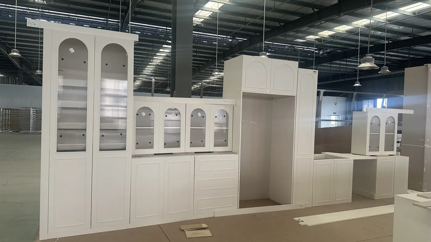 Arched cream cabinetry units in factory
