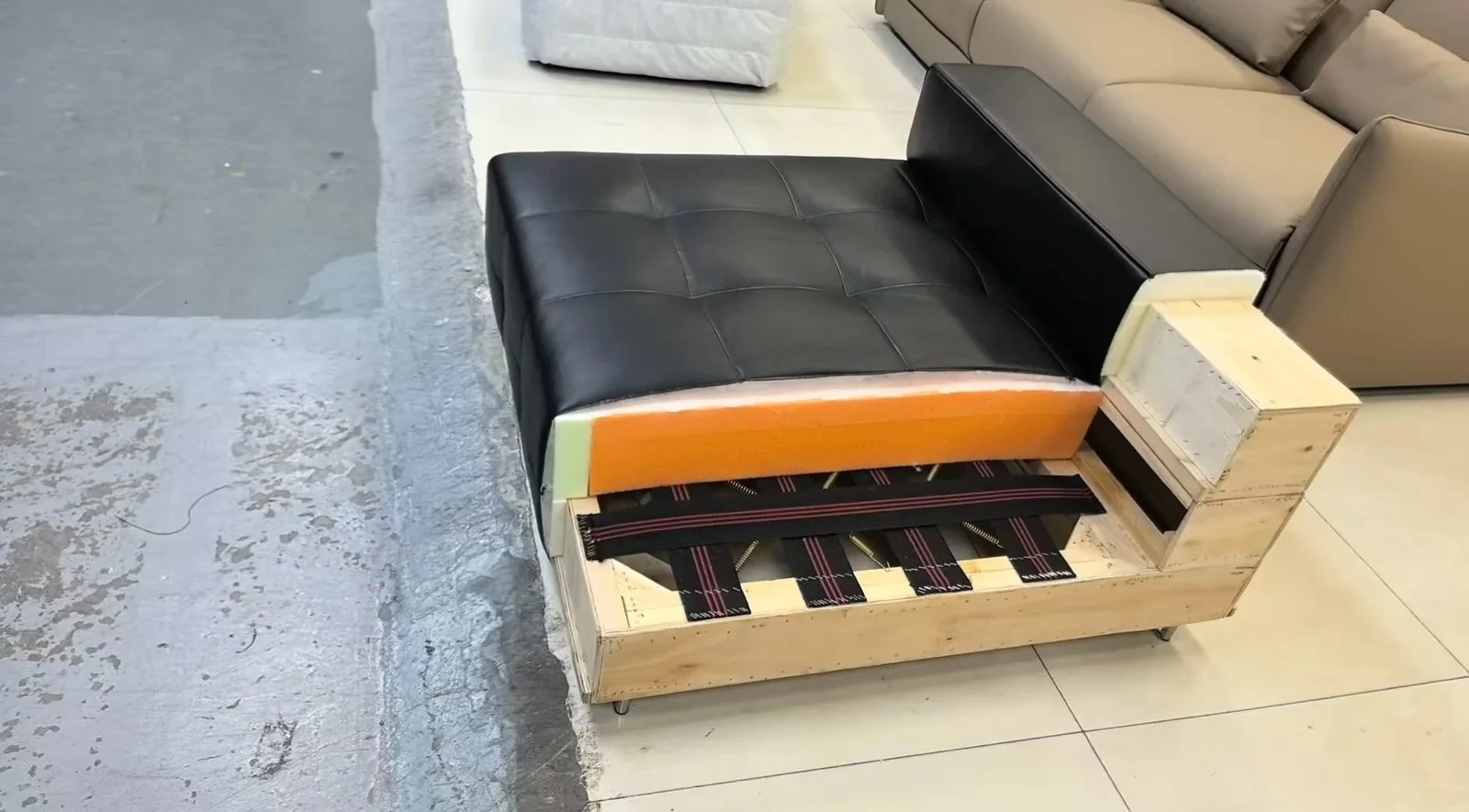 Sofa seat opened to reveal cushion and support layers