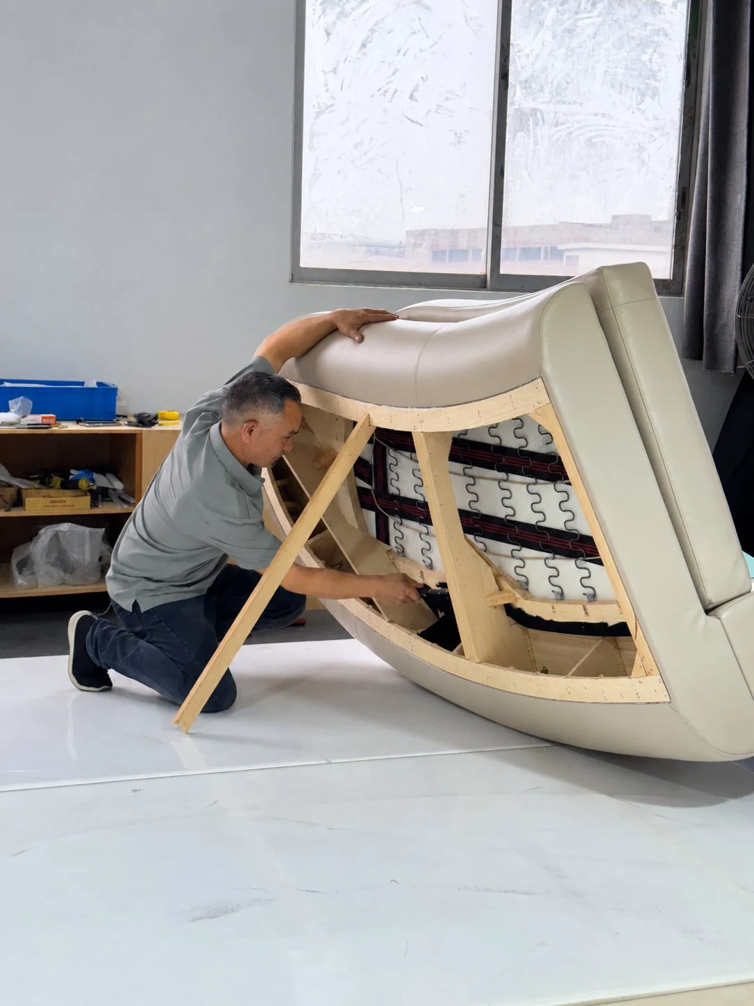 Curved sofa shell being upholstered over the frame