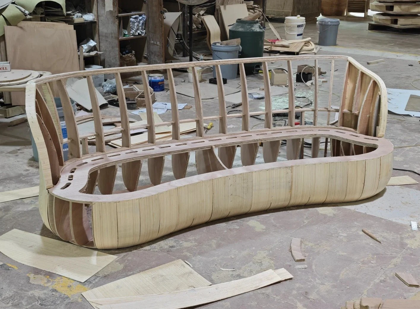 Large curved timber sofa frame in production