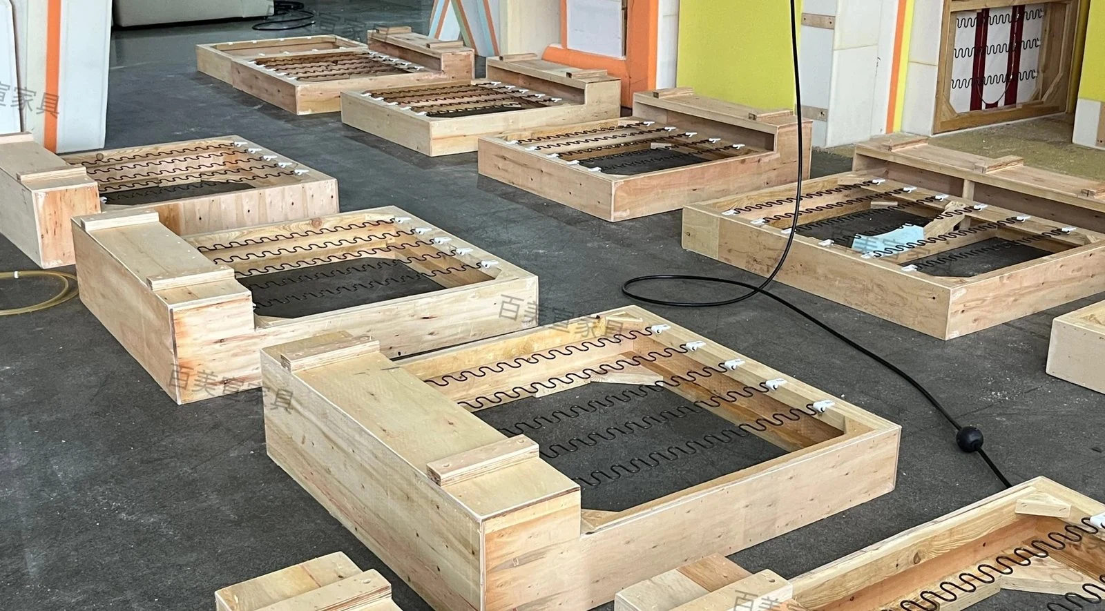 Multiple timber sofa frames prepared as a production batch