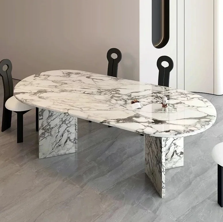Oval white marble dining table with bold grey veining