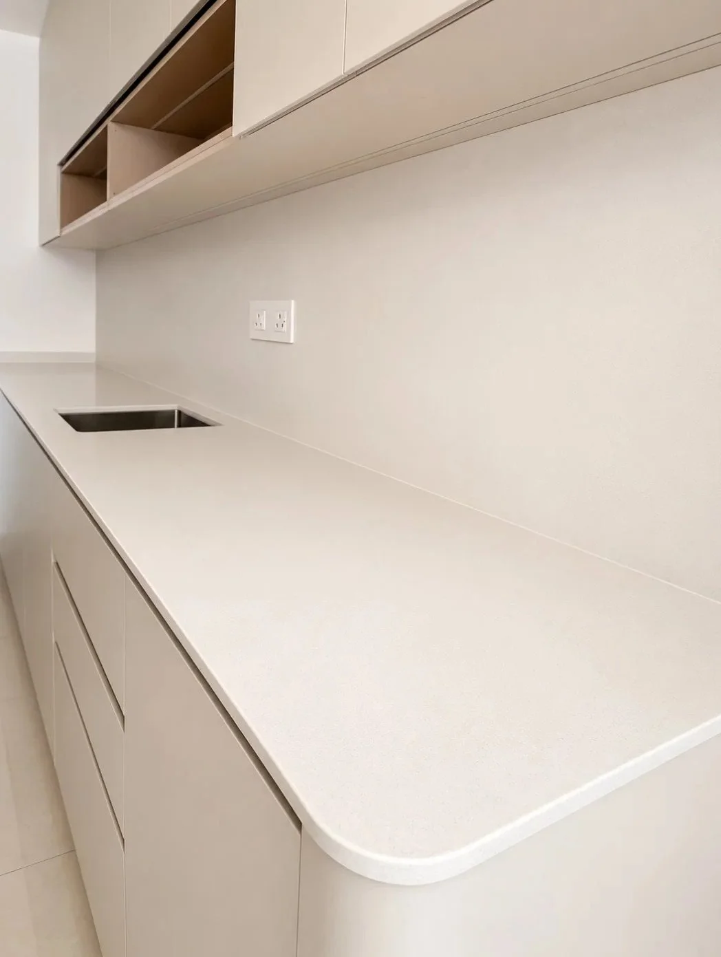 Seamless white quartz countertop in a minimalist kitchen