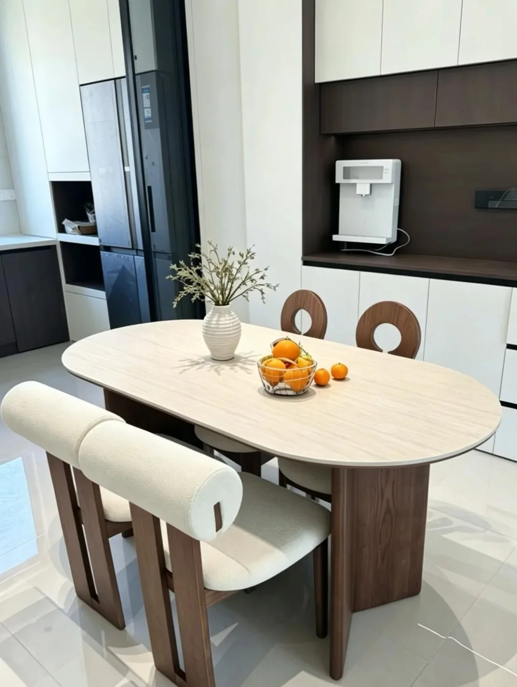 Travertine-look sintered stone dining table in a modern kitchen