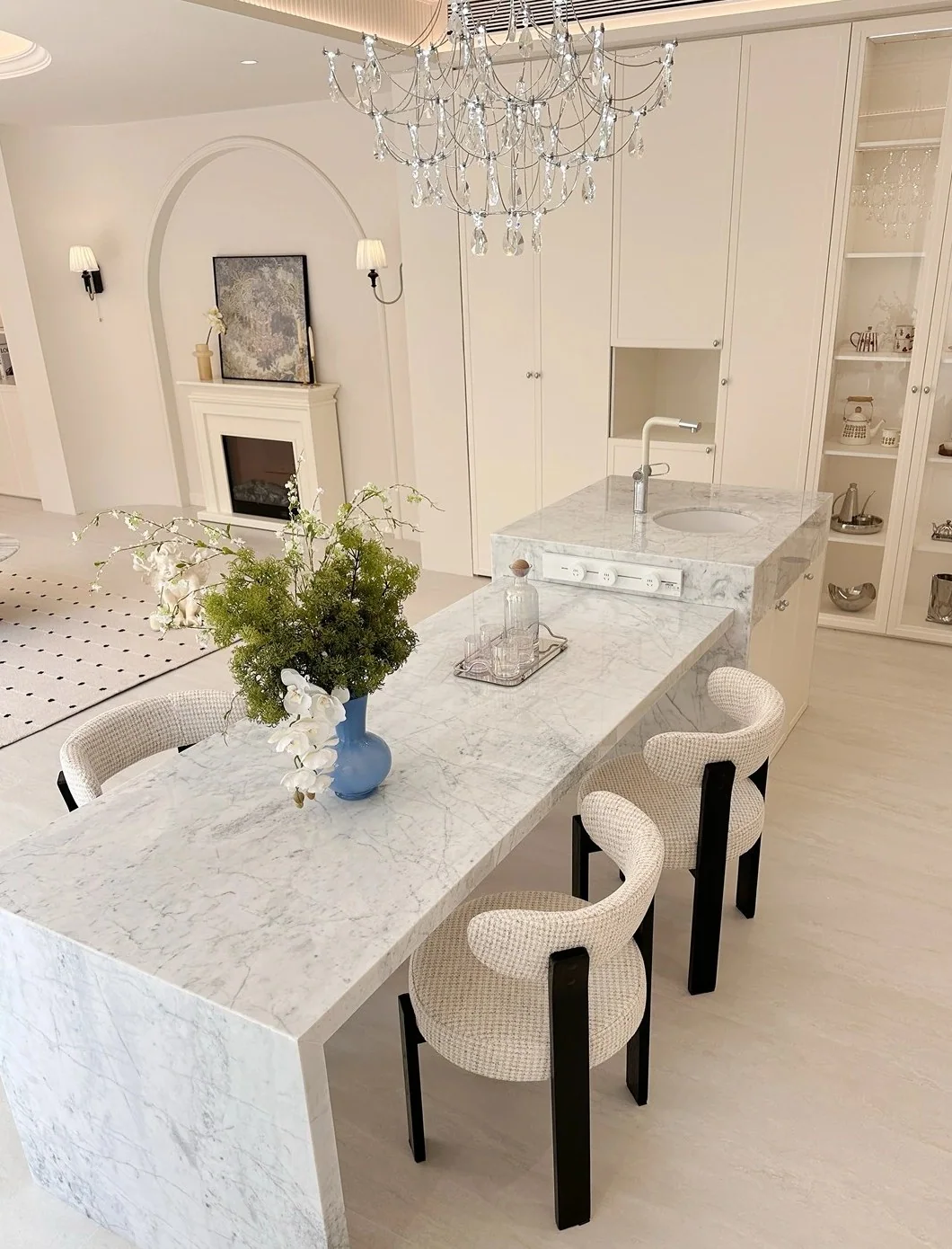 Large stone waterfall kitchen island with integrated dining seating