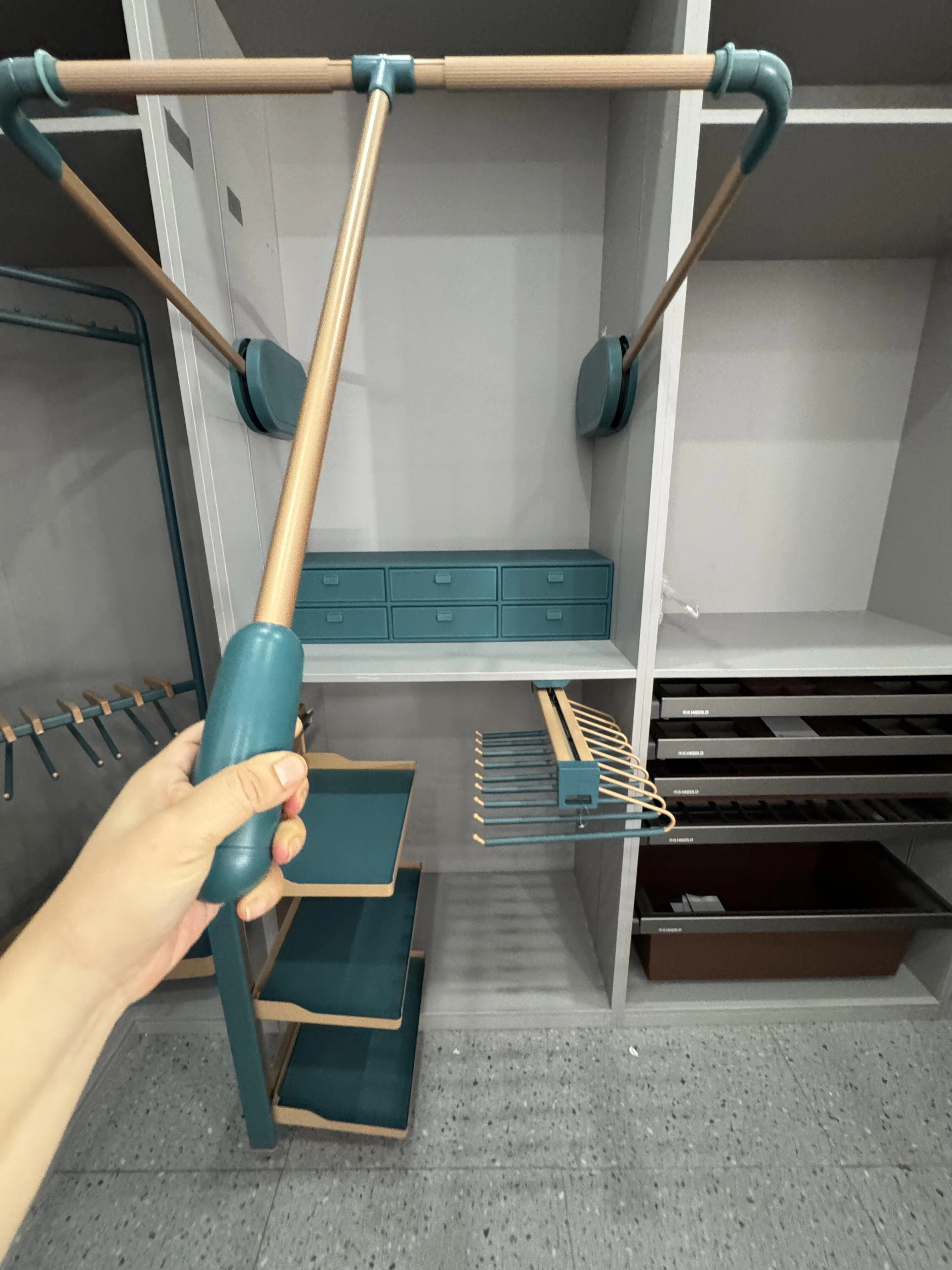 Pull-out wardrobe hardware being tested through its full movement range before shipment.
