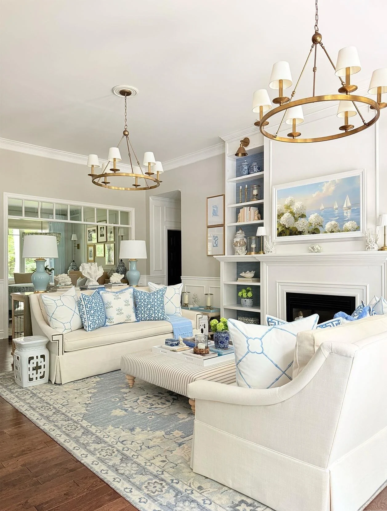 Classic coastal living room with white seating and blue accents