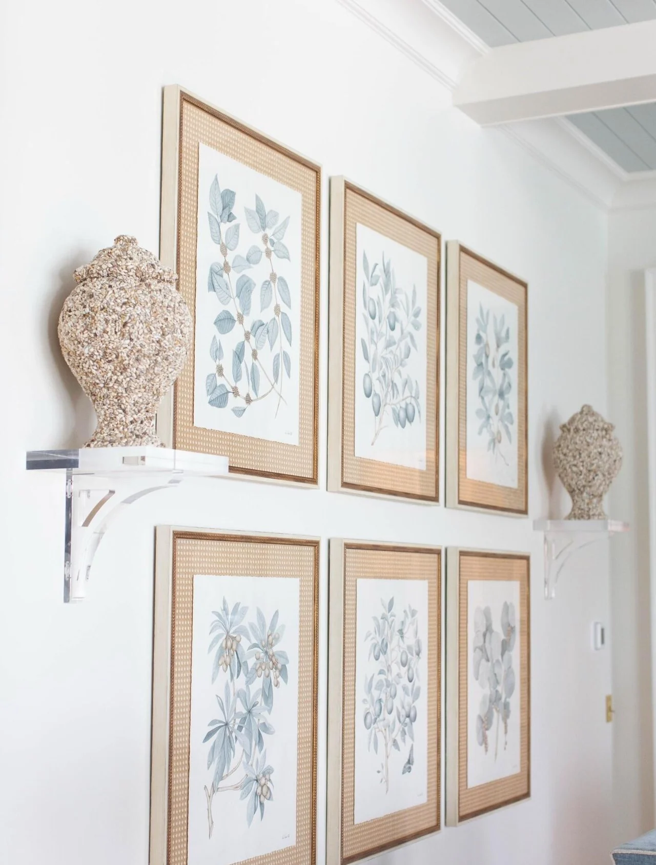 Gallery wall with botanical art in a coastal home