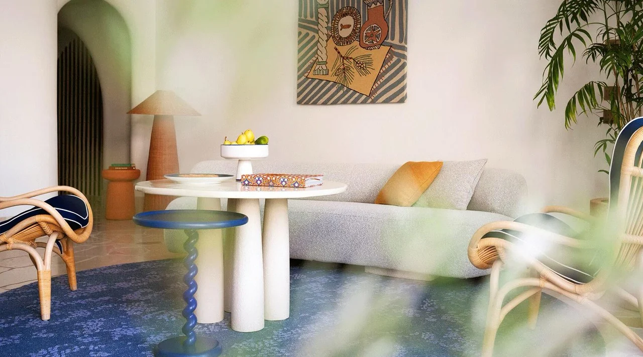 Sunlit coastal lounge with curves and woven chairs