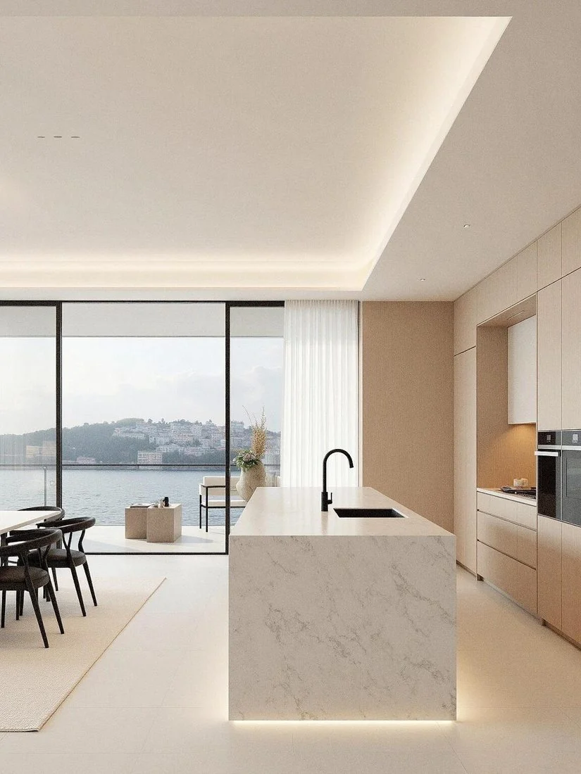 Pale wood and veined stone add warmth to a restrained kitchen.