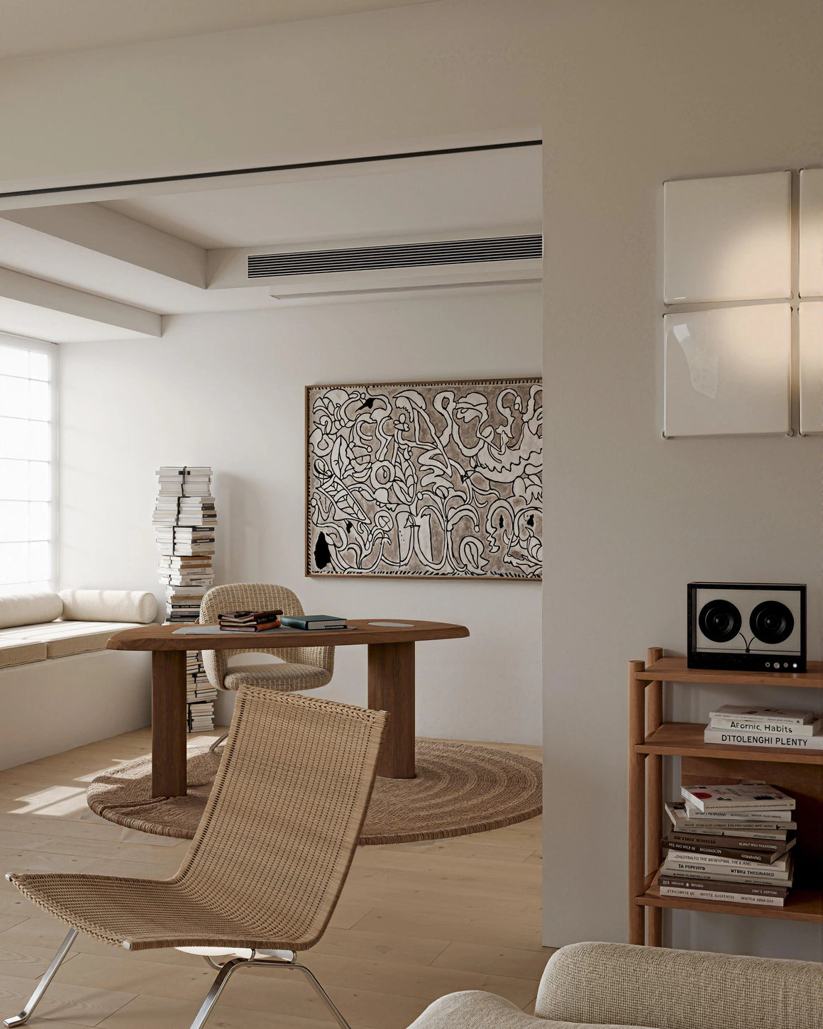 Japandi furniture grouping with rounded wooden table, woven chair and pale plaster wall