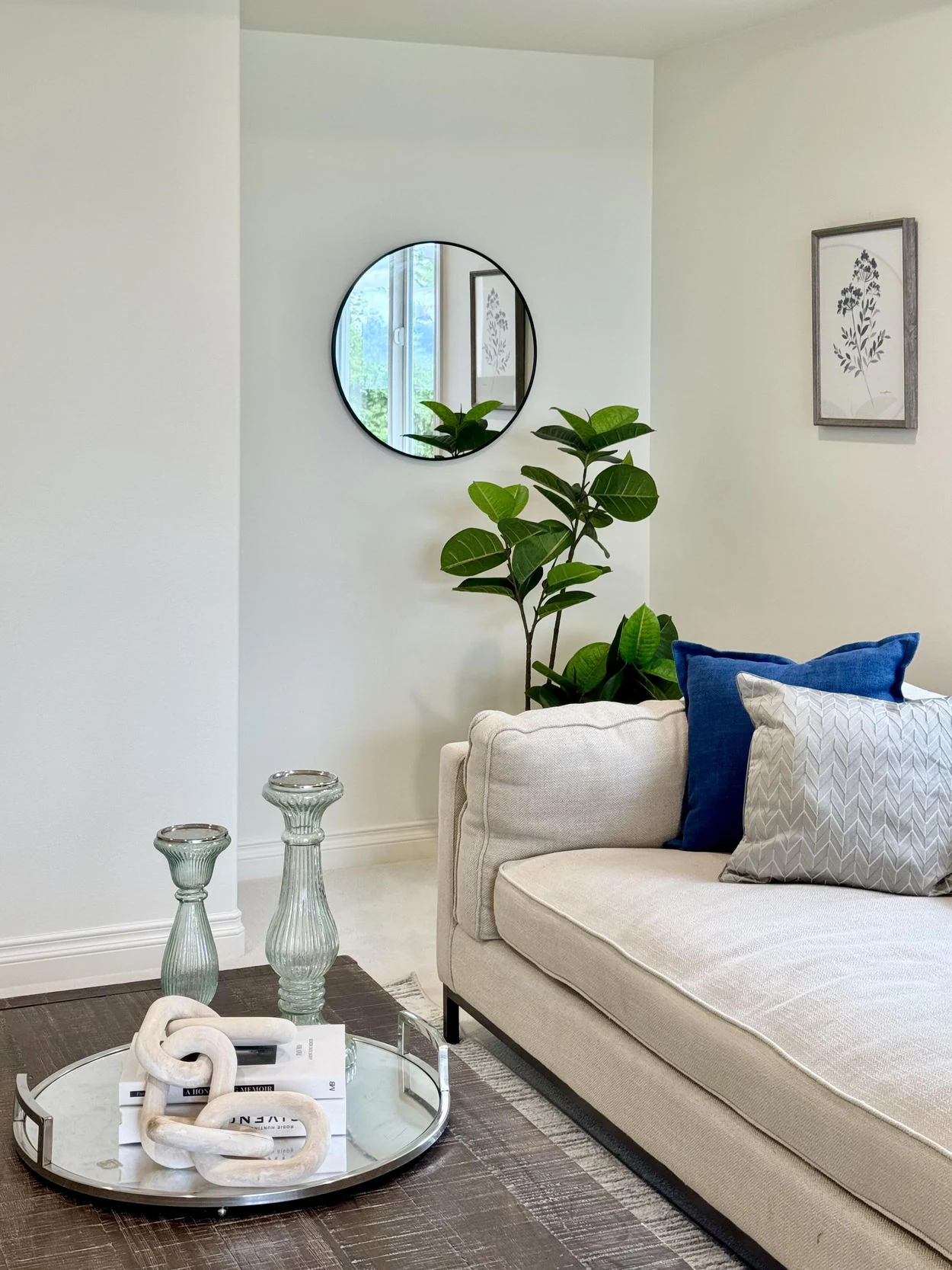Neutral sofa with a blue cushion and botanical details