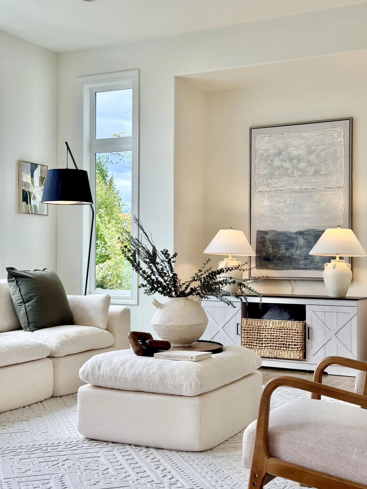Ivory living room seating with wood accent chair and upholstered ottoman