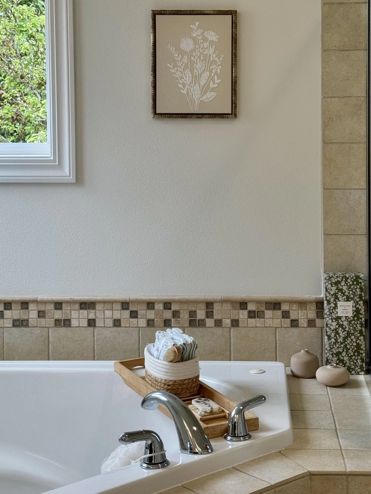 Bathroom tub with pale tile and simple metal fixtures