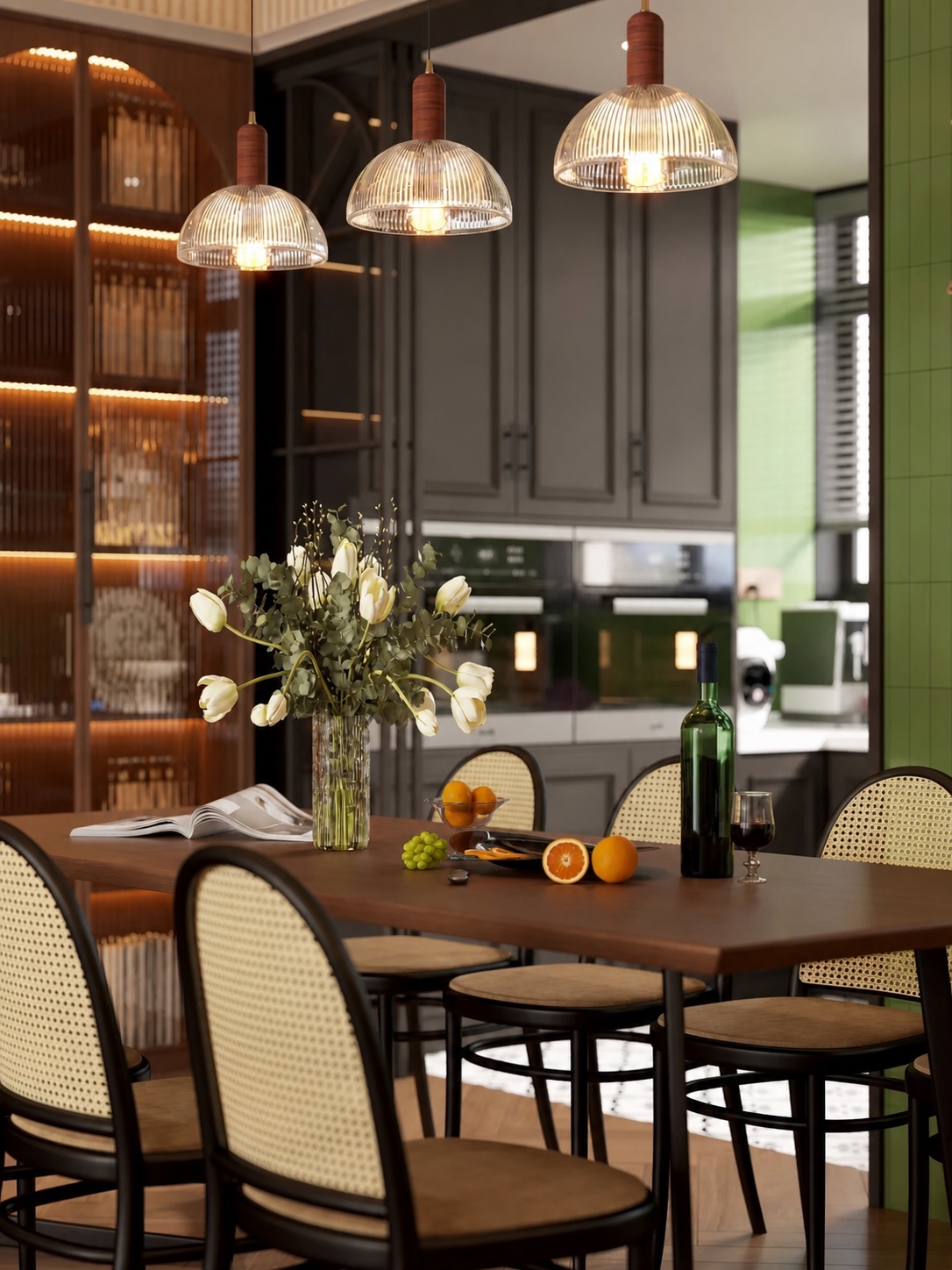 Cane dining chairs around a walnut table beneath three ribbed glass pendant lights